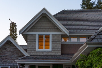Two story stucco luxury house with nice Spring blossom landscape at night in Vancouver, Canada, North America. May 2025.
