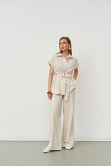 Stylish woman posing confidently in a chic fashion outfit indoors