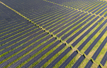 Aerial view of solar power station on a green field. Sustainable development.
