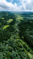 Fototapeta premium Lush green hills and forested mountains frame a sustainable village, highlighted by wind turbines under a blue sky at golden hour