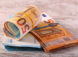 Bundles of euro banknotes on table