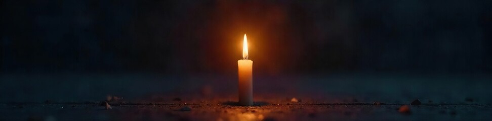 Fototapeta premium A single, glowing candle flame in complete darkness, representing hope and spiritual enlightenment, a path to salvation , contemplation, grace