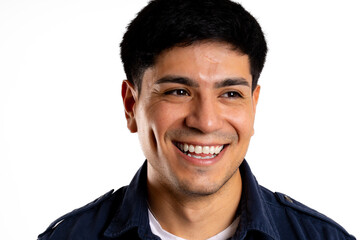 Face of young Latin man laughing happily looking away in white background