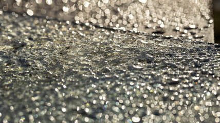 Glittering and Shimmering Water Droplets on a Surface Exposed to Beautiful Sunlight and Natural Light