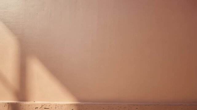 Shadows cast on a peach wall with textured baseboard creating abstract geometric patterns in sunlight background texture video