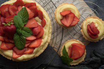 Homemade Strawberry Tart with Cream and Mint on Rustic Background