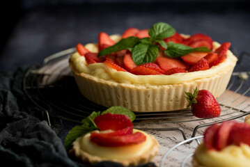 Homemade Strawberry Tart with Cream and Mint on Rustic Background