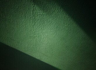 Dramatic light of ray on vintage green wall background