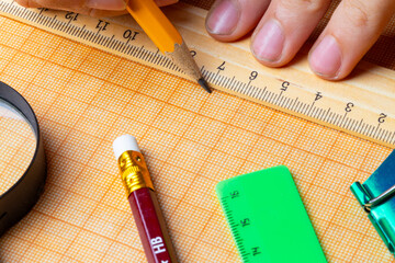 draftsman draws on a ruler