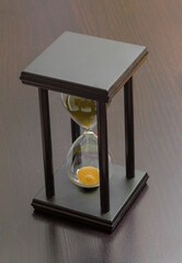 Black hourglass on black background