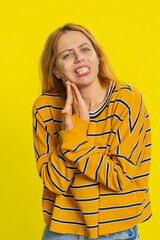 Dental problems. Caucasian blonde young woman touching cheek, closing eyes with expression of...