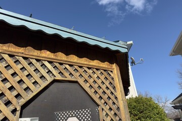 wooden lattice gazebo against blue sky