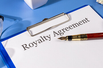 Royalty Agreement Form in Clipboard on Desk – Intellectual Property Law Setting