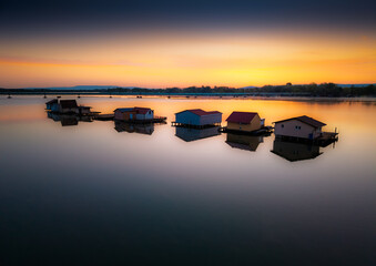 Floating village at sunset in Hungary showcasing tranquil waters and charming homes
