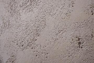 Gray texture of decorative plaster travertine close-up. Wall decor