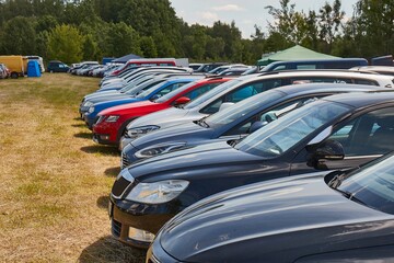 Many Cars Parking on Grass by a Festival