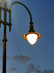 Street lighting. Burning park lantern in retro style against dark sky in close-up