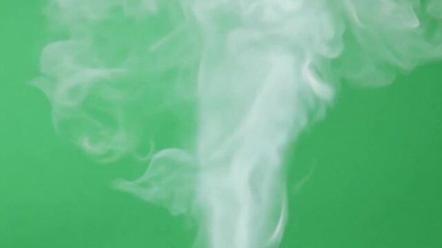Thick plume of white smoke rises against a green chroma backdrop, offering a bold and adaptable visual for media and video projects. Generative AI