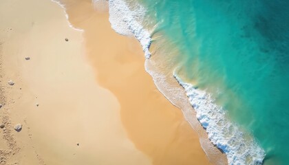 Aerial view of sandy beach with turquoise ocean water and waves. Gentle waves wash golden sand coast. Calm shoreline and blue sea create summer mood for vacation and recreation.