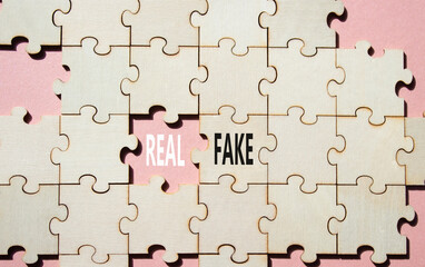 Real or Fake symbol. Concept word Real or Fake on wooden blocks. Beautiful pink background....