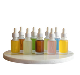 Set of skincare serum bottles in frosted glass with dropper caps arranged neatly on a white marble slab, Isolated Transparent Background