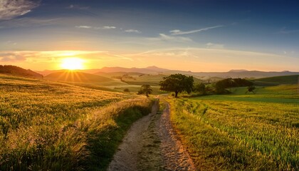 Obraz premium serene countryside landscape with rolling green fields a dirt path leading into the horizon and a golden sunrise casting a warm glow over the rural scenery