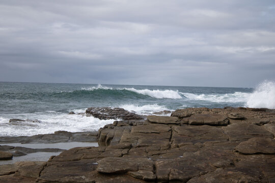 Various waves from the ocean crashing onto the rocks on the south coast of South Africa, located at Orange Rocks in Uvongo in Margate