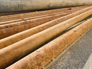 Old metal rusty pipes, industrial pipes, construction oxidized iron pipes.