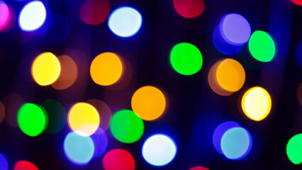 Multicolored Bokeh Background with Blurred Yellow Green Blue Orange Circles on Dark Background