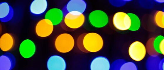Multicolored Bokeh Background with Blurred Yellow Green Blue Orange Circles on Dark Background