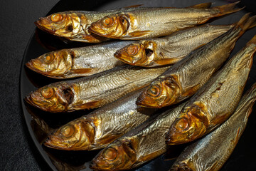 Tasty and salty smoked sprats marinated with salt and spices. Smoked fish marinated with herbs and...