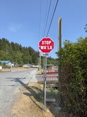 Multilingual road traffic stop sign in English and Kwak'wala-speaking Pacific Northwest Coast Indigenous people. British Columbia, Canada