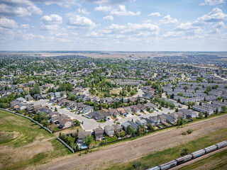 City view with a lot of houses and a train in the background