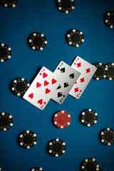 On the card table are three sevens and the playing chips from winning poker, displaying two pairs of cards and a lively atmosphere perfect for an evening of gaming