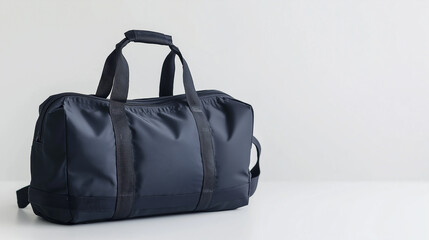 A durable black gym bag with multiple compartments and a shoulder strap, isolated on a white background.
