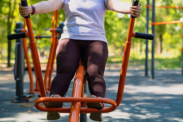 Woman Working Out on Outdoor Exercise Equipment in the Park