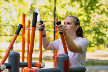 Woman Working Out on Outdoor Exercise Equipment in the Park
