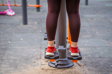 Woman Working Out on Outdoor Exercise Equipment in the Park