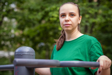 Woman Working Out on Outdoor Exercise Equipment in the Park