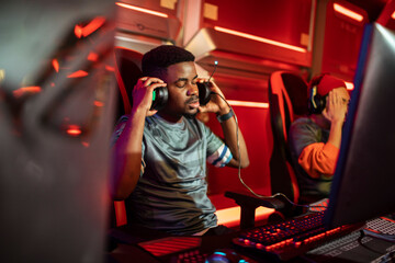 Young male gamer with eyes closed in frustration after losing a game at esports arena