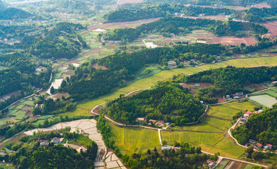 aerial view of farm field in between hills
