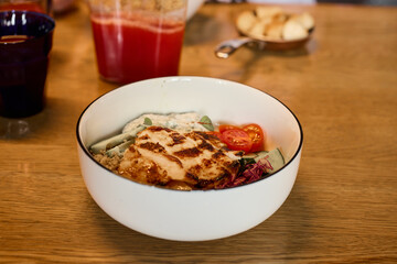 Enjoy a delicious chicken bowl that features an array of fresh, colorful vegetables