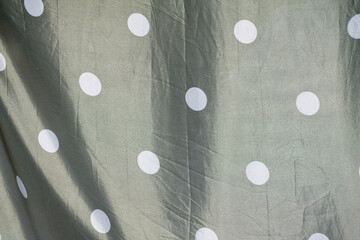 Olive Green Fabric with White Polka Dots Draped Texture Background Subtle Elegance Fashion Design...