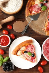 Tasty pizza and ingredients on wooden table, flat lay