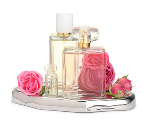 Many different perfume bottles and roses isolated on white