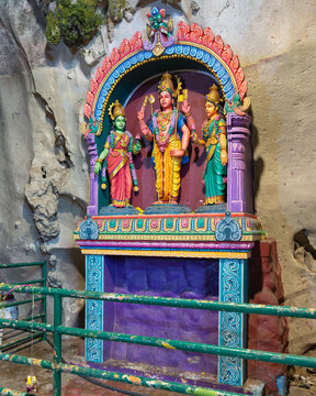 Kuala Lumpur, Malaysia - Feb. 18, 2025: Colorful statues of Hindu deities Murugan, Valli, and Devasena in an ornate shrine inside the Batu Caves temple complex
