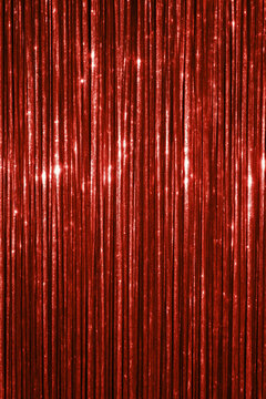 Shimmering red tinsel curtain with sparkling festive texture for party decoration