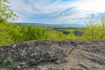 View from rock formation in the place of ancient prehistoric ocean trench, nestled within a green forested environment. Rim rocks formation, Western Canada Sedimentary Basin, Alberta