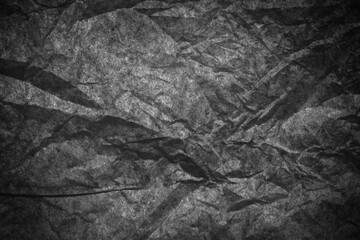 Black paper wrinkle crumpled  texture abstract on background