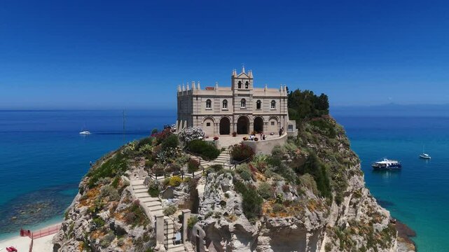 Aerial view of the Sanctuary of Santa Maria dell Isola on a rocky islet overlooking Tropea beach, Calabria, Southern Italy